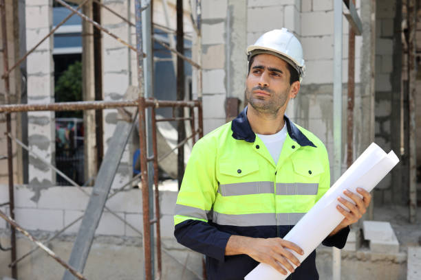 istock Caucasian technician civil engineer man or specialist inspector standing and planing real estate project work with blueprint while checking at Industrial building site. Construction concept 1495231580