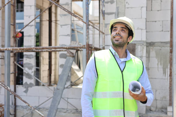 istock Caucasian technician civil engineer man or specialist inspector standing and planing real estate project work with blueprint while checking at Industrial building site. Construction concept 1495231611