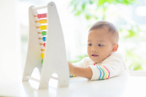 istock Baby boy playing with wooden abacus. 1495231773