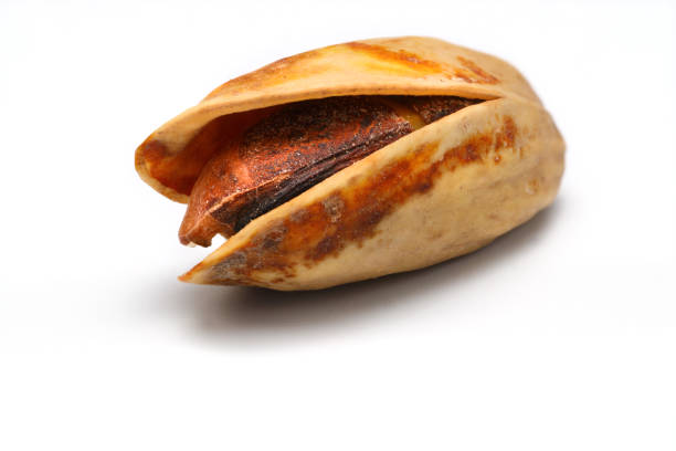 Heap pistachios isolated on white background, close up.