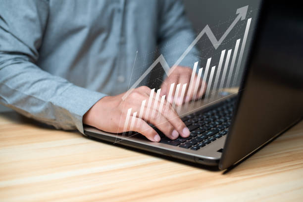 istock Business developmetn and tecnology concept. Businessman using laptop with technical growing up graph on virtual hologram display. Planning and strategy, Financial investment and trading. 1495235536
