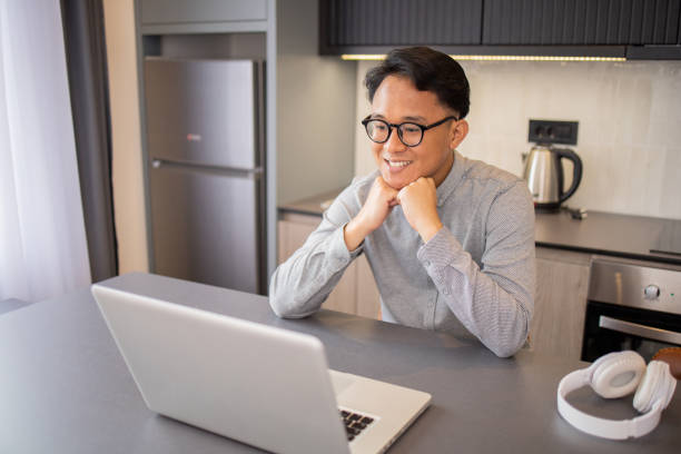 istock Young fashionable man working at home 1495235988