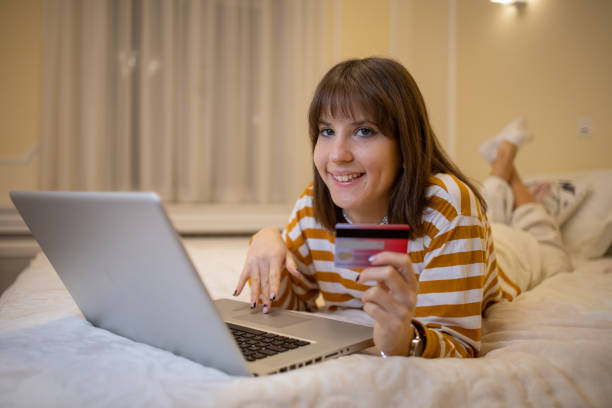 istock Cheerful  woman doing online shopping 1495236930