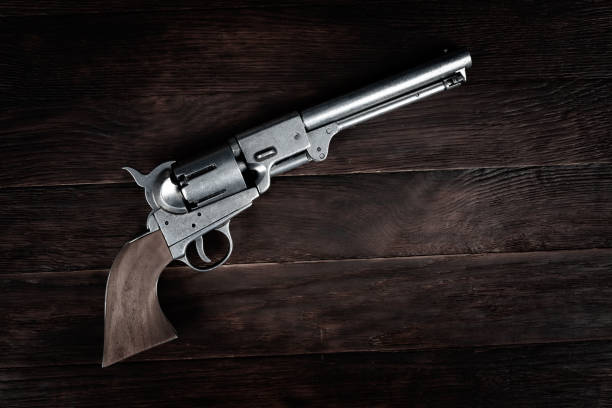 istock Old west gun. Colt Revolver on wooden deck. 1495238065