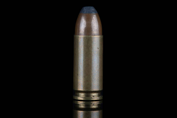 istock 9mm caliber round with reflexion on black with reflexion. 1495239276