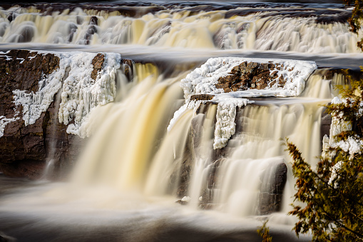 Close-up of Partially Frozen Scenic Waterfall in Winter (long exposure)