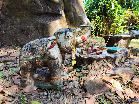 Incense in front of an elephant carved on a rock at Vat Phou sanctuary, a ruined Khmer Hindu temple complex in southern Laos and one of the oldest places of worship in Southeast Asia. It is at the base of mount Lingaparvata, some 6 kilometres from the Mekong in Champasak Province.