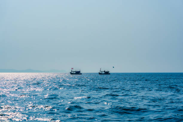 istock Fishing boat floating on blue sea 1495248930
