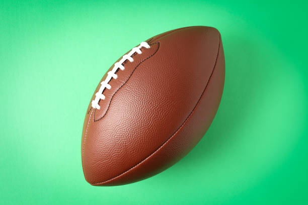 istock American football ball on mint background, space for text 1495249314