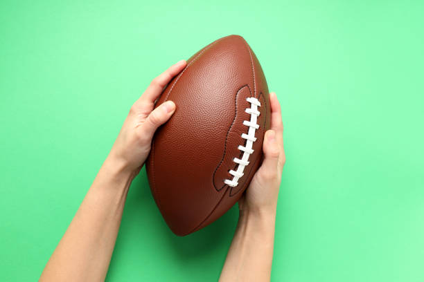 istock American football ball on mint background, space for text 1495249481