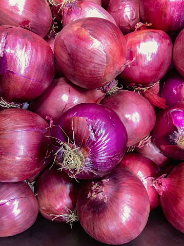 A large pile of delicious, fresh, red onions.