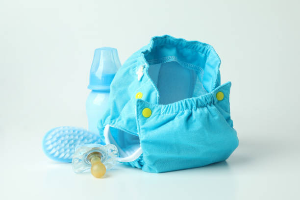 istock Concept of baby clothes with reusable diapers on white table 1495252620
