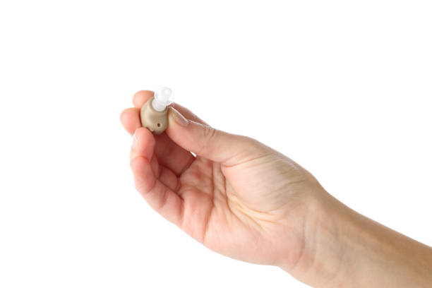 istock Hand holds hearing aid, isolated on white background 1495255596
