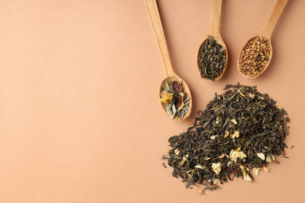 istock Concept of cooking tea with different types of tea on beige background 1495256875