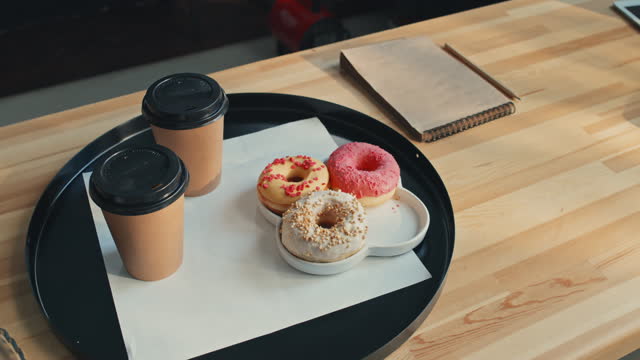 Two Cups Of Coffee And Donuts On Tray