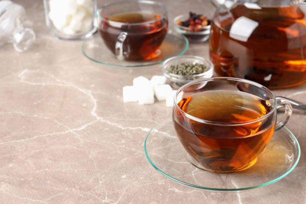 istock Concept of hot drink with tea on beige textured background 1495258185