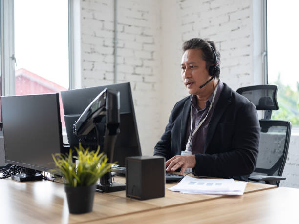 istock Senior men working at office with headset 1495267609
