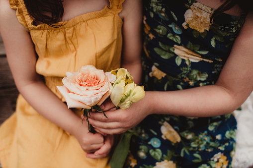 Sisters holding roses and tulips