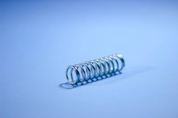 istock A spring made of metal is placed on a blue table 1495271620