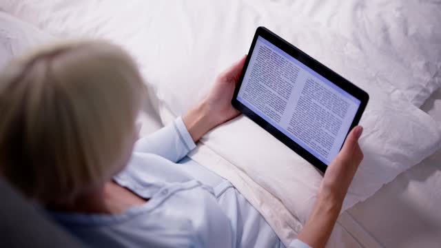 Young Woman Reading Ebook On Digital Tablet