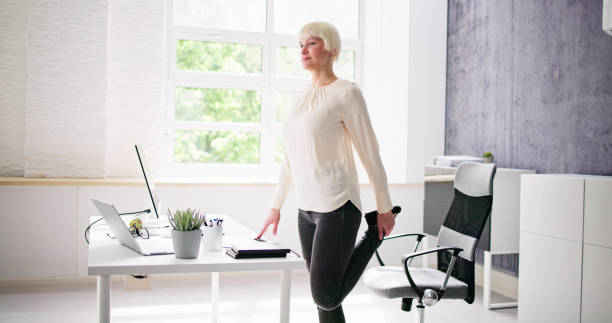 istock Yoga Workout In Office Behind Business Computer 1495275437