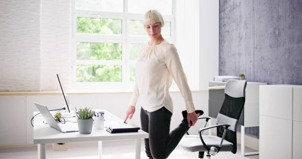 istock Yoga Workout In Office Behind Business Computer 1495275466