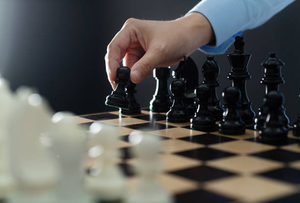 istock Man hand holding chess pawn 1495275488