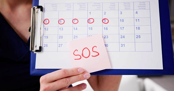 Woman Using Menstrual Cycle Or Period Calendar