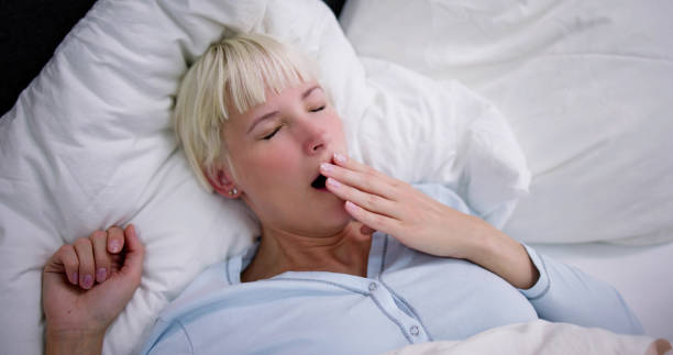 istock Young Woman Yawning In Bed 1495275847