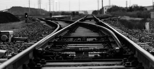 Railways. Metal steel rails and wooden sleepers. Rivets and fasteners on the railroad. Stony backfill of railway tracks. Station Nyrki, Karelia