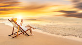 Woman using digital tablet at the beach