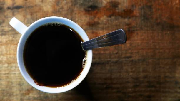 istock Coffee cup on the table. Coffee break. Black coffee time. Drinking coffee. Coffee table top angle 1495275956