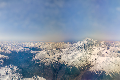 From the window of a commercial aircraft, an awe-inspiring sight unfolds as passengers are treated to an extraordinary aerial view of Nanga Parbat, also known as the 