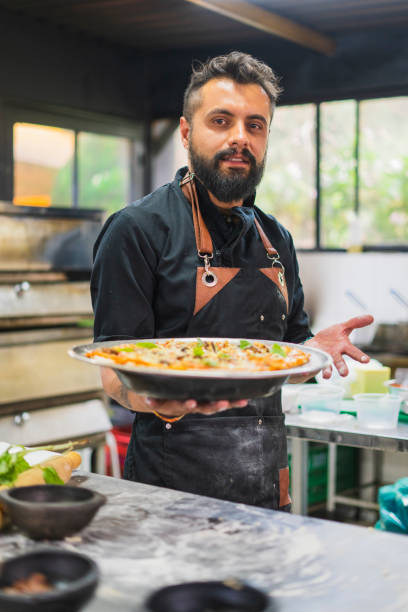 istock Chef is making vegan pizza at restaurant 1495279611