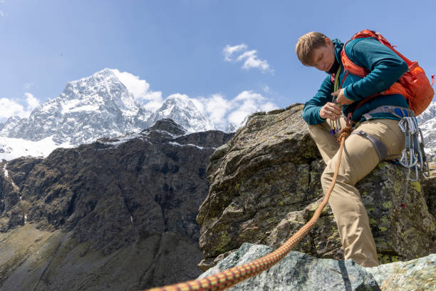 istock Mountain climber chooses gear for protection 1495281805