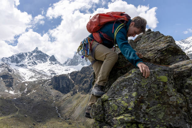 istock Mountain climber ascends final steps of summit 1495282328
