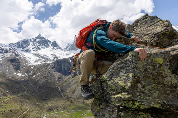 istock Mountain climber ascends final steps of summit 1495282329