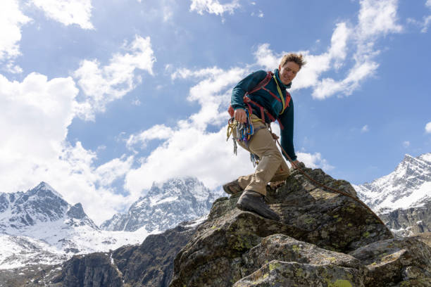 istock Mountain climber reaches top of mountain 1495282344