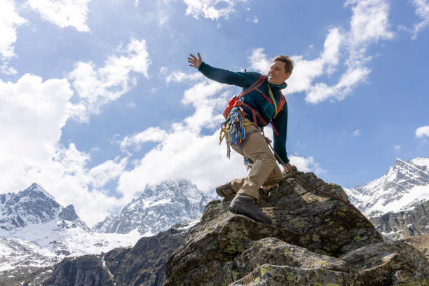 istock Mountain climber reaches top of mountain 1495282353