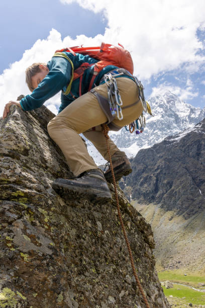 istock Mountain climber ascends final steps of summit 1495282362
