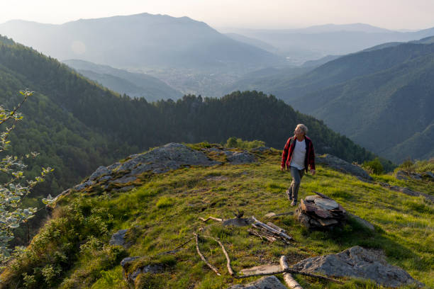 istock Senior man hikes up mountain ridge 1495282426