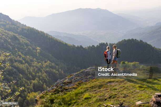 Mother And Adult Daughter Hike On Mountain Ridge Stock Photo - Download Image Now - 25-29 Years, 60-64 Years, Achievement