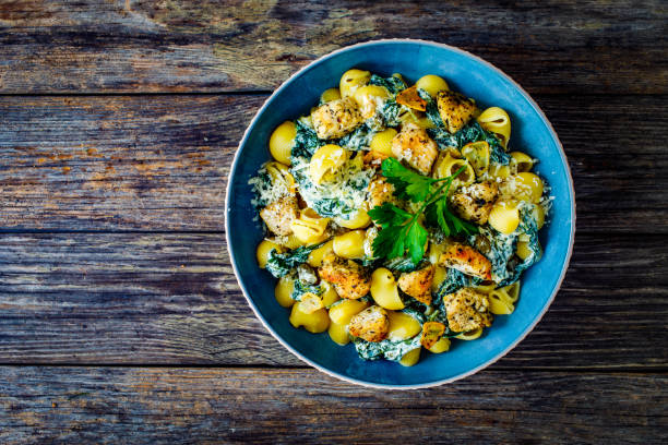 istock Noodles with seared chicken nuggets, spinach and parmesan 1495284721