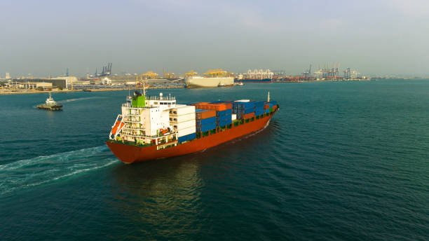 istock cargo container ship carrying in sea to import export goods and distributing products to dealer and consumers across asia pacific worldwide, global business and industry delivery service  by container ship Transport. 1495285074