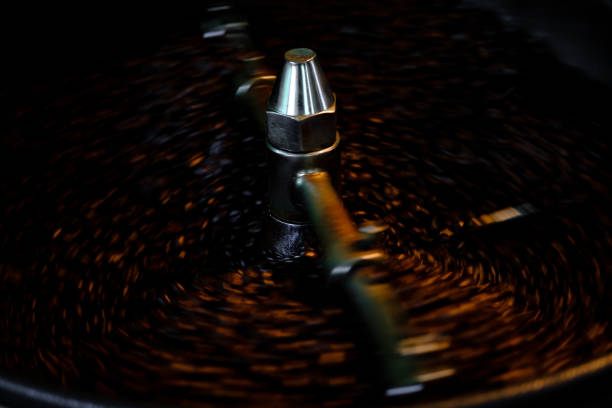 abstract background Coffee beans in Roasted machine and close up selective focus long exposure shot Motion blur background .Coffee process industry community concept