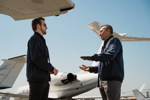 istock Two pilots are discussing their previous flight in front of the aircraft. 1495286098