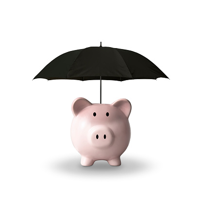 Close-up of piggy bank with black umbrella on white background.