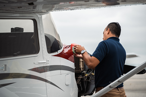An engineer performs maintenance on the aircraft's propeller.
