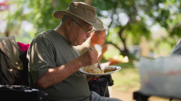 Farming community and family members taking a break from working and having lunch