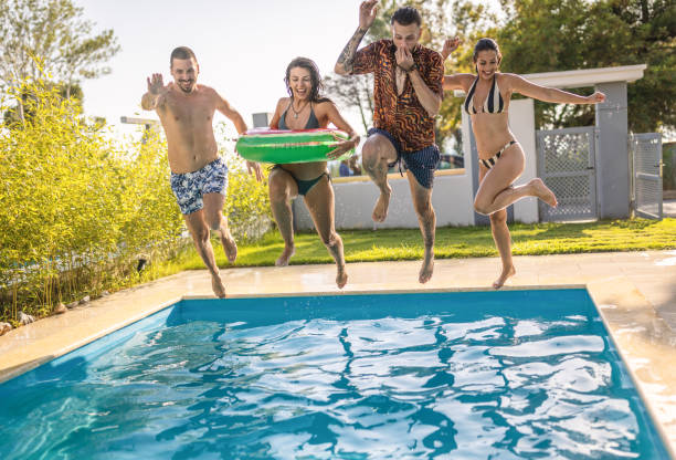 istock Group of friends juming in swimming pool. 1495291106